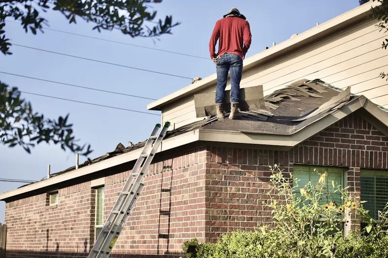 Professional roofer working on a residential roof in Sunset Plaza